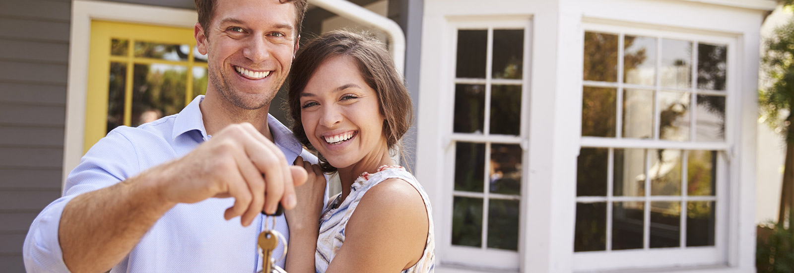Young couple with keys to new house