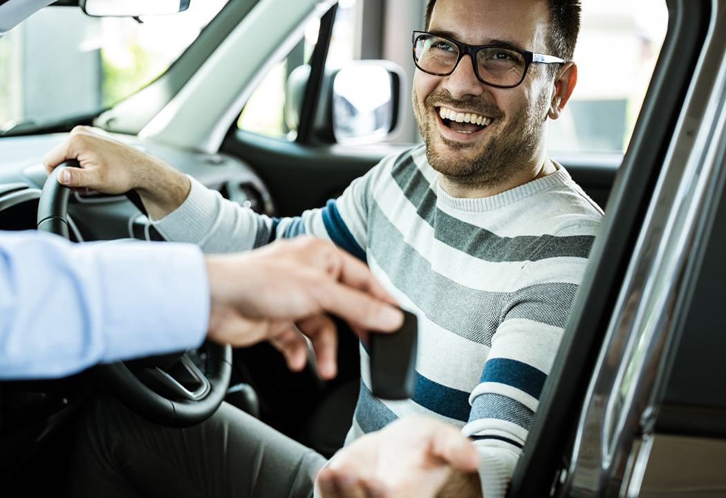 Person getting keys to new vehicle.
