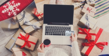 Holiday shopping on laptop using NEFCU credit card